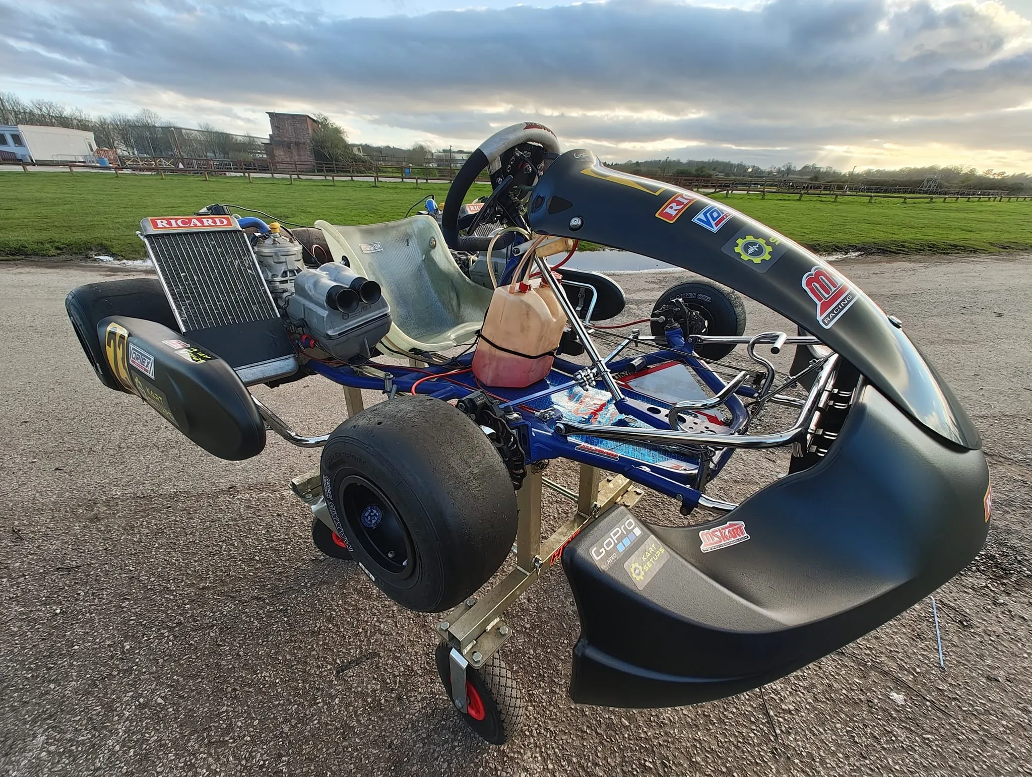 The twin-engine OK kart on its stand at the circuit, radiator and twin airbox on show